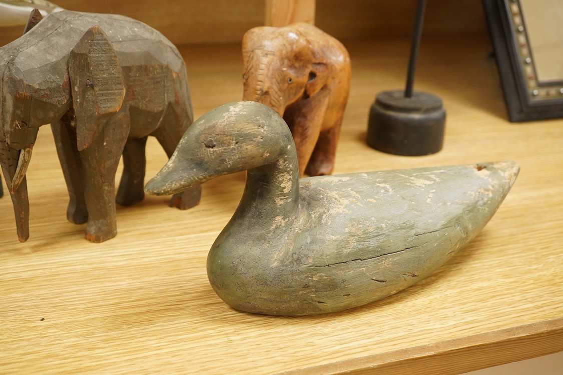 A carved and painted decoy duck, two carved elephants and two other painted birds, tallest 41cm